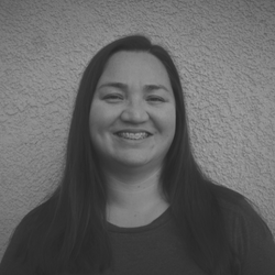 A black and white photo of a woman smiling.